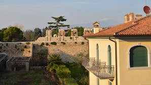 A building with a stone wall and a balcony.