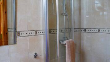 Bathtub, hair dryer, towels, toilet paper