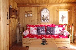 Relax in a cozy room with a wooden coffee table and sofa, featuring a rustic ambiance.