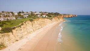 A coastal landscape with a sandy beach, cliffs, and a residential area with houses. - Spacious villa near town [46] (Lagos)