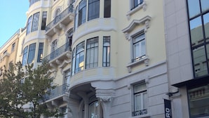 A multi-story building with ornate architectural details, including arched windows and decorative moldings.