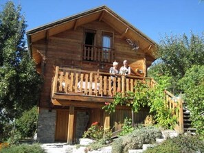 A wooden cabin with a balcony, stone foundation, and a small garden. - Chalet - Chorges (Chorges)