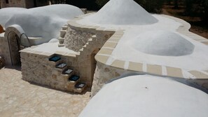 A stone structure with a circular design and a small staircase leading up to a platform.