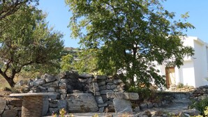 A stone wall with a white building in the background. - La Bolina-unique romantic holiday experience, private infinity pool, huge views (torrox)