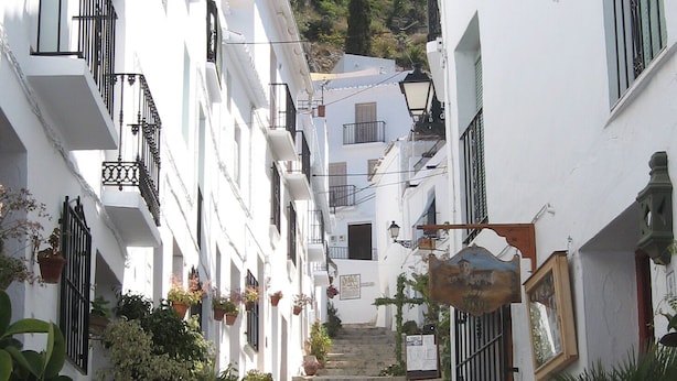 A narrow street with white buildings, stone steps, and potted plants. - La Bolina-unique romantic holiday experience, private infinity pool, huge views (torrox)