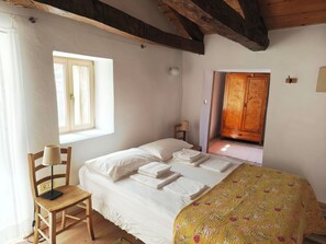 A bedroom with a bed, a chair, a wooden wardrobe, and a window. - Tuscan-Style Stone Hideaway Peaceful Rural Retreat near the Coast (Koper)