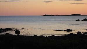 A coastal landscape with a calm sea, rocky shoreline, and distant landforms. - Cozy vacation home for 5 people in Hallandsåsen. (Hjärnarp)