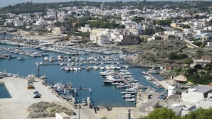 A marina with numerous boats docked, surrounded by residential buildings and greenery. - ONLY 150 METERS FROM THE SEA OF S. SALENTO- MARIA DI LEUCA- PESCOLUSE-Torrevado (Leuca)