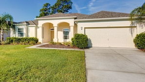 A single-story house with a garage, a front porch with columns, and a well-maintained lawn. - Spacious Exec Villa With Large Private Pool. Stunning Golf Course and Lake Views (Davenport)