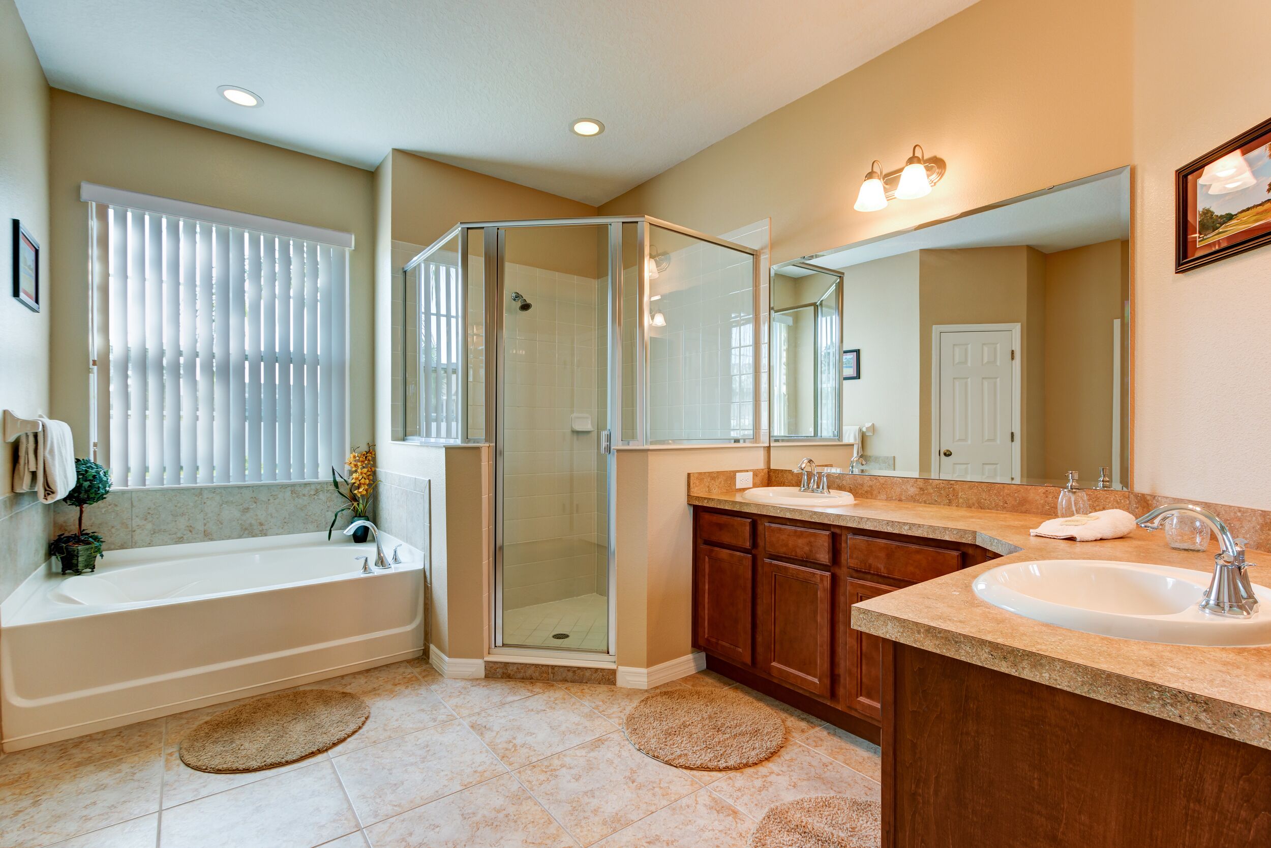 A modern bathroom with a bathtub, a shower enclosure, and a vanity with a sink.