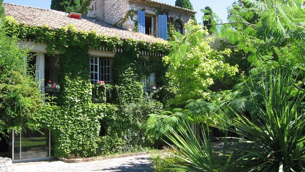 A stone house with a tiled roof, surrounded by lush greenery and a well-maintained garden. - Lovely Old Stone Bastide With Private Pool, Short Drive To Beach (Vence)