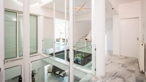 A modern interior with a glass staircase, white walls, and a marble floor. - Stunning villa for private Escape/ Create priceless memories! large private pool (Hania)