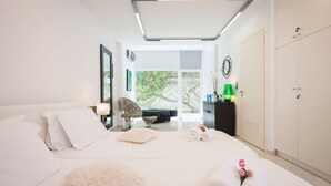 A modern bedroom with a large bed, a desk, and a wardrobe. - Stunning villa for private Escape/ Create priceless memories! large private pool (Hania)