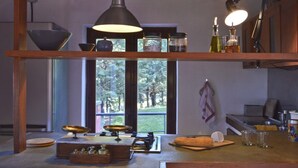 A kitchen with a large window, wooden shelves, and various kitchen items. - House with pool, sea views near Cefalu and Castelbuono and beach 10 minutes (Pollina)