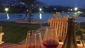 A wooden table with two wine glasses and a bottle of wine.
