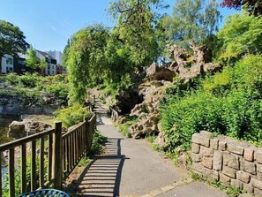 A paved pathway with a wooden railing, surrounded by greenery and rocky terrain. - ARRAS BEAUTIFUL HOUSE, LARGE TERRACE WITH VIEW ON VERY NICE PARK (Arras)