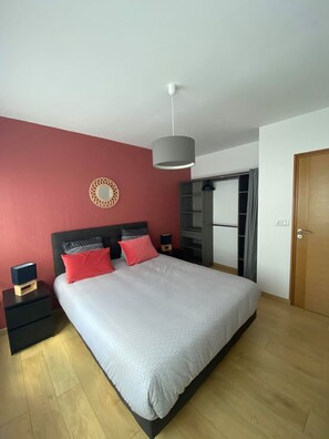A modern bedroom with a large bed, a bedside table, a nightstand, a wardrobe, and a hanging light fixture. - ARRAS BEAUTIFUL HOUSE, LARGE TERRACE WITH VIEW ON VERY NICE PARK (Arras)