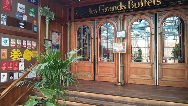 A traditional building with ornate wooden doors and large windows, featuring plaques and signs on the walls. - Near the sea , the quiet and the charm of " LA  FORGE" (Narbonne)