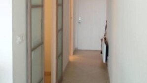 A narrow hallway with a sliding door on the left and a closed door at the end. - Apartment/ flat - Bandol,  Sea front, A/C, private parking place (Bandol)
