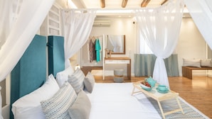 A bedroom with a bed, a bedside table with a tray, a mirror, and a wardrobe. - Dafni Villa, a Blissful Retreat with 40m² Pool (Rethymno)