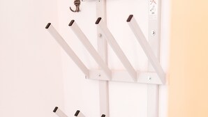 A white metal rack with multiple hooks against a wall. - Chalet Vergissmeinnicht, spacious property in Zell am See, includes Summer Card (Zell am See)