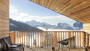 A wooden deck with a view of snow-capped mountains and a forested valley. - Barma Chalet - Luxurious modern chalet, exceptional view, 900 m from the slopes (Manigod)