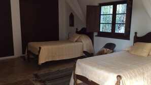 A bedroom with two beds, a window, and a wooden floor. - 2 Bedroom, Fully Air-conditioned Country House With Large Private Pool (santa barbara de nexe)