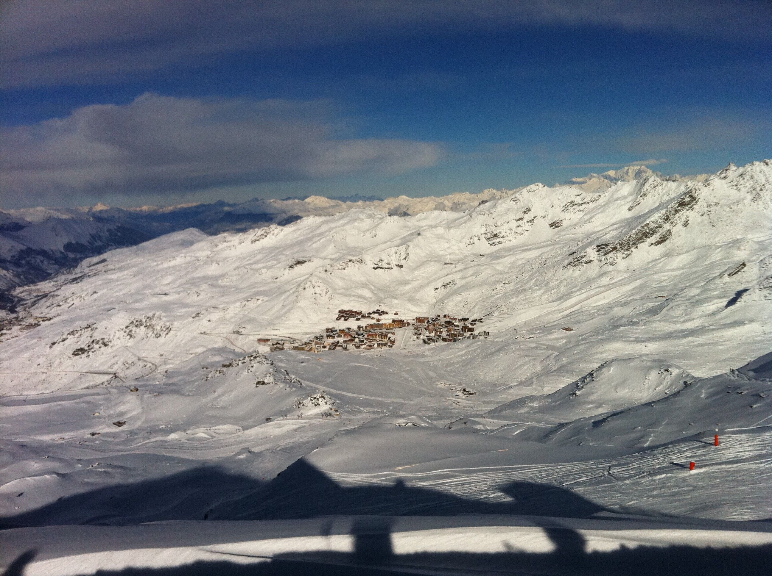 A snow-covered mountain landscape with a small settlement.