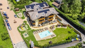 An aerial view of a hotel with multiple buildings, a swimming pool, and a parking lot. - Residence Toli Pool with outdoor heated Pool 30° (Ledro)