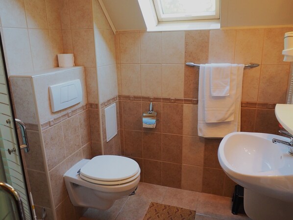 A bathroom with a toilet, sink, towel rack, and a window. - Large mountain holiday villa with magnificent views, Brasov (Brasov)