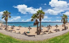 On the beach, sun loungers, beach towels