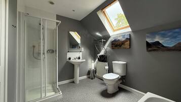Bathtub, towels, soap, toilet paper