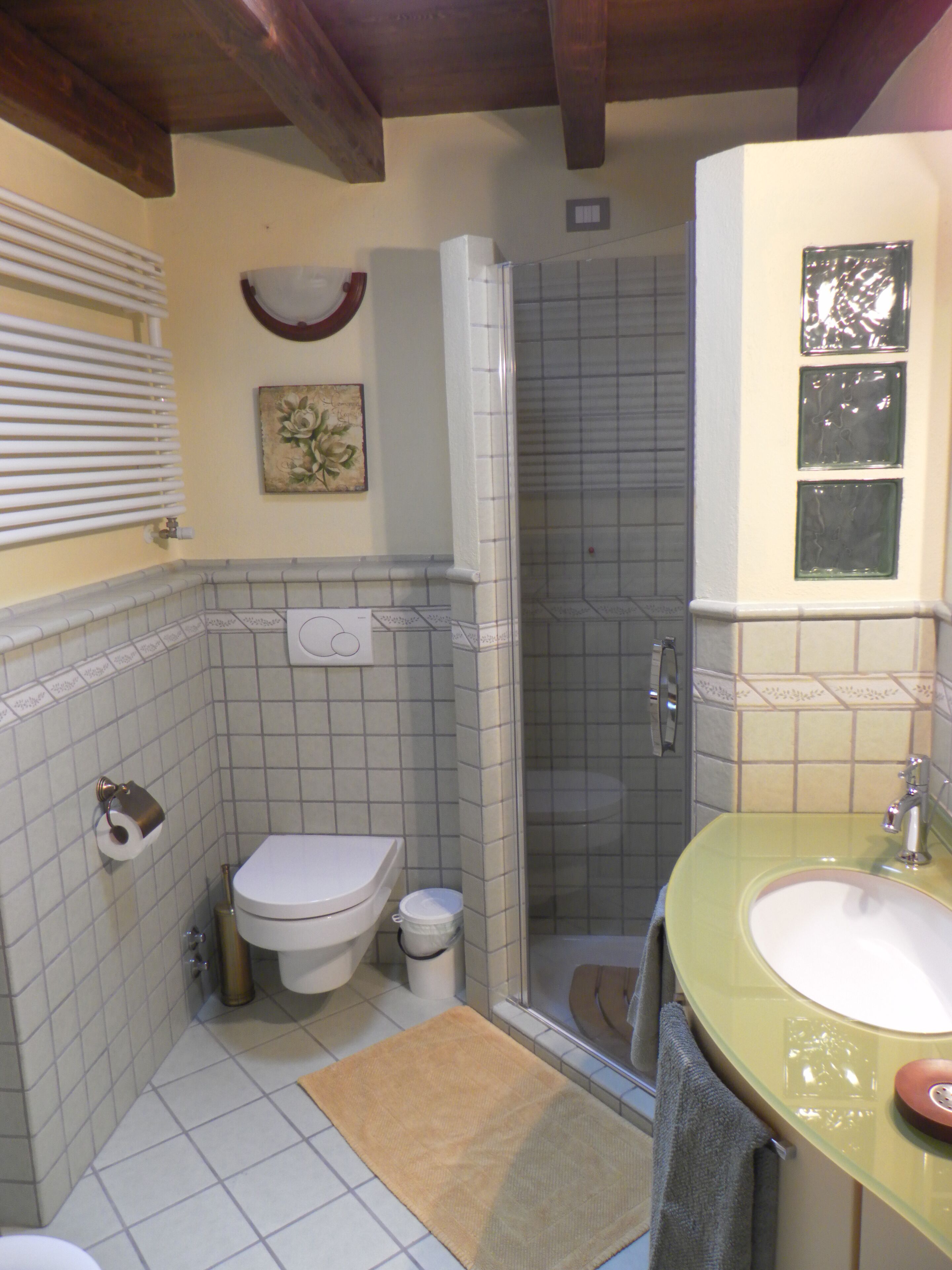 A bathroom with a toilet, sink, and shower.