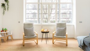 A room with two chairs, a small table, and a window with blinds. - Feel Porto Downtown Heaven (Oporto)