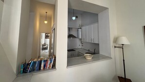 A compact kitchen with a built-in window, a sink, and a small countertop. - Charming apartment in the Old Town of Seville, next to Santa Cruz. (Sevilla)
