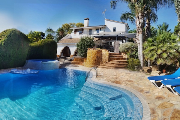 Front of house with pool and garden views