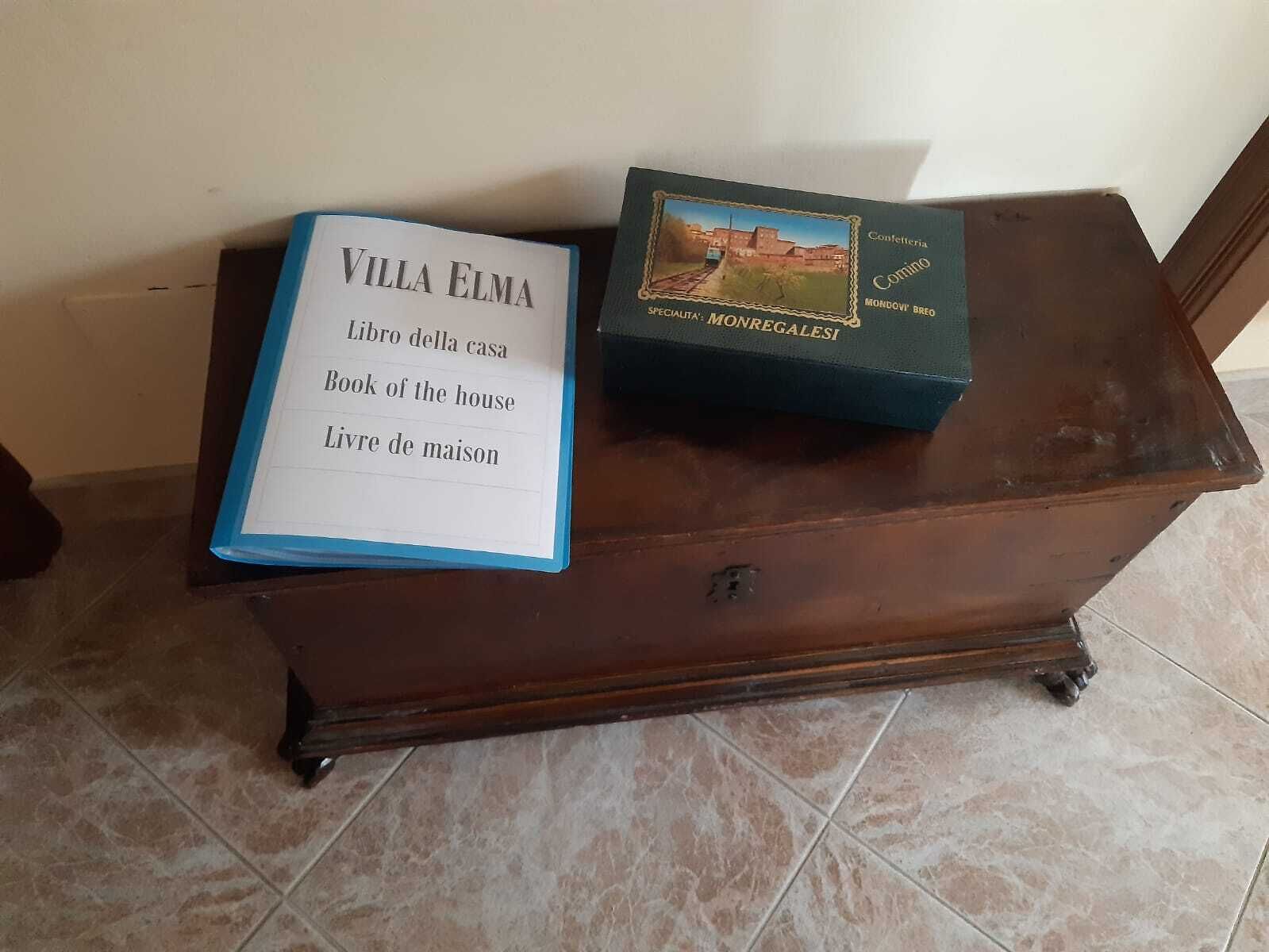 Two books on a wooden dresser with a tiled floor.