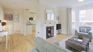 A spacious living room with a fireplace, a television, and a comfortable seating area.