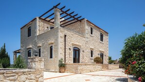 A stone building with a pergola, arched windows, and a stone pathway. - Stone Made villa in picturesque village! Private pool & full privacy! (Rethymno)