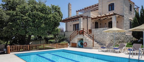 A heated pool, sun loungers