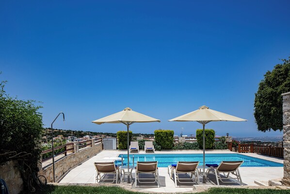 A heated pool, sun loungers