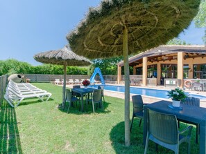 A poolside area with a table and chairs, a thatched umbrella, and a slide. - 10 Bedrooms Villa|Tennis & Basketball court|Soccer Field|Near Beaches &Barcelona (sils)