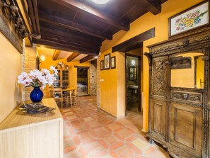 A hallway with a wooden ceiling, a stone floor, and a wooden cabinet with intricate carvings. - 10 Bedrooms Villa|Tennis & Basketball court|Soccer Field|Near Beaches &Barcelona (sils)
