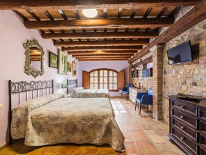 A room with two beds, a TV, a stone wall, and a wooden ceiling. - 10 Bedrooms Villa|Tennis & Basketball court|Soccer Field|Near Beaches &Barcelona (sils)