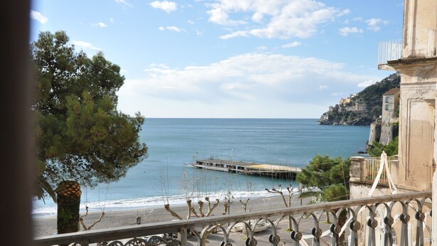 A coastal view from a balcony with a railing, overlooking the sea and a pier. - L'Ancora - Bright Sea front, Self Catering Apartment (Minori)