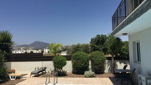 A rooftop pool with a view of distant buildings and mountains. - Private Pool, Private Location, Free Wifi, All Day Sunbathing in private garden (Alethriko)
