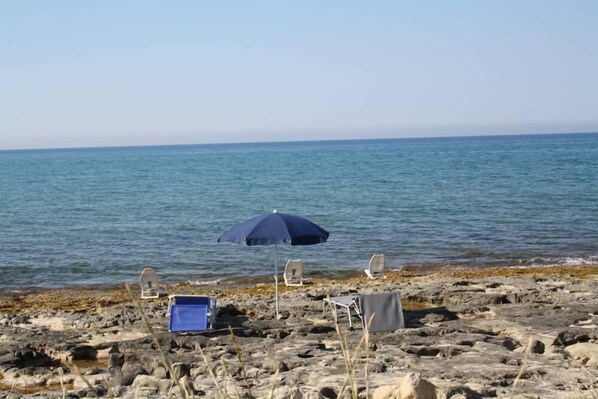 On the beach, sun-loungers