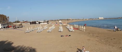 On the beach, sun-loungers