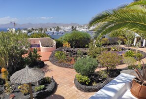 A rooftop garden with various plants and a view of the city and mountains in the background. - Beautiful modern 2 bed apartment with a stunning sea view and close to the beach (Puerto del Carmen)