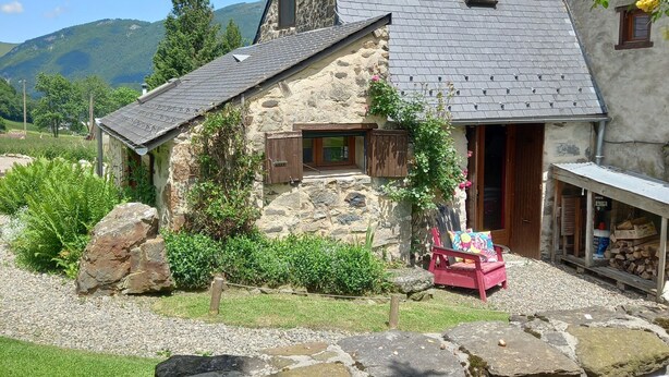 A stone house with a sloped roof, a small porch, and a gravel driveway. - With Stunning Views, A Great Location For Mountain Activities And Relaxing (Campan)
